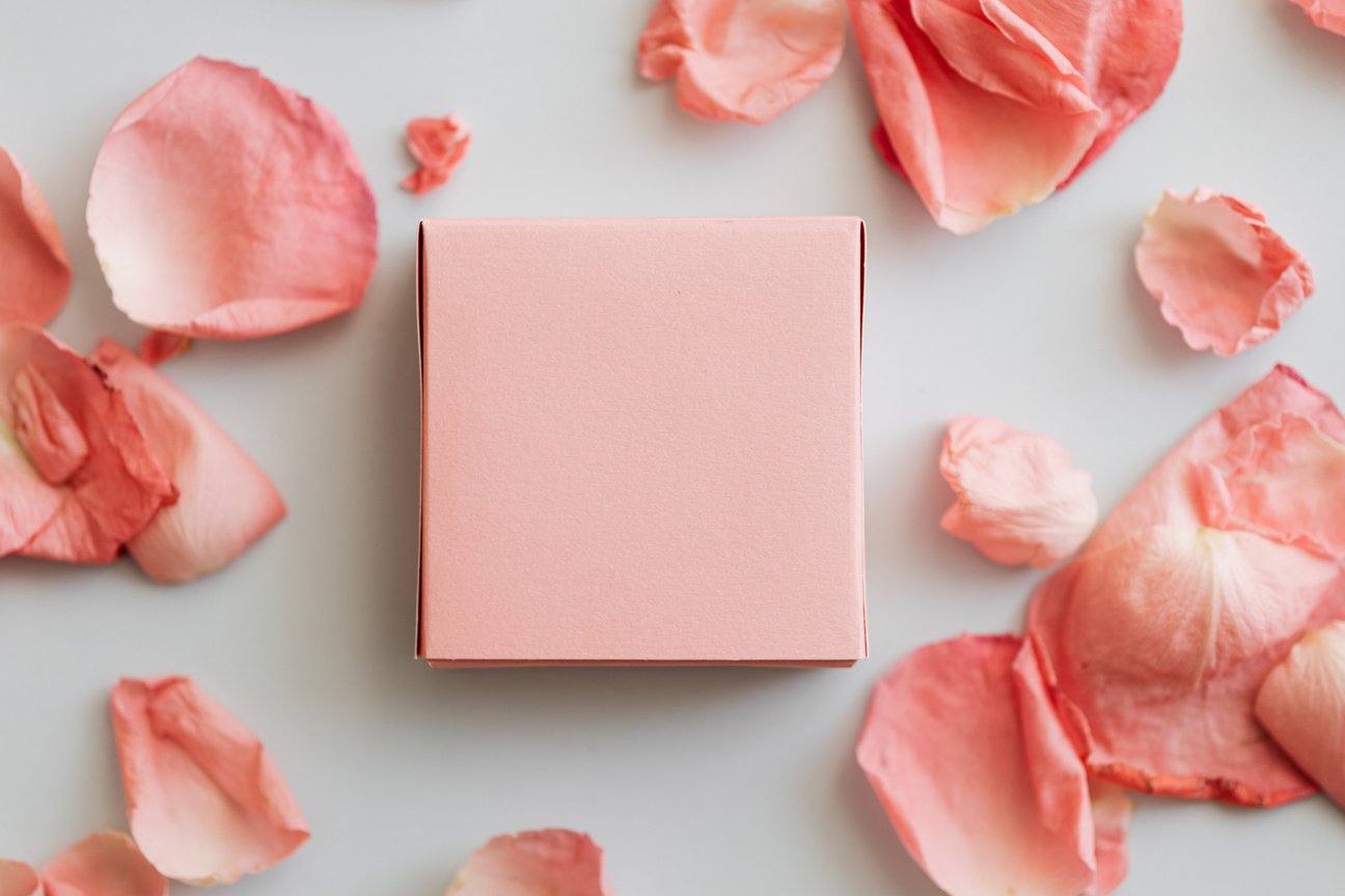 Pink gift box and scattered petals